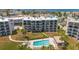 Aerial view of a condo building with a pool and ocean views at 9815 Harrell Ave # 302, Treasure Island, FL 33706