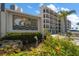 Building entrance with landscaping and Blind Pass Lagoons signage at 9815 Harrell Ave # 302, Treasure Island, FL 33706
