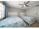 Two twin beds, window with blinds, ceiling fan, and coastal decor at 9815 Harrell Ave # 302, Treasure Island, FL 33706