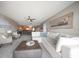 Living area with sectional sofa, coffee table, and view to dining area at 9815 Harrell Ave # 302, Treasure Island, FL 33706