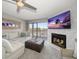Living room with fireplace, large TV, and waterfront views at 9815 Harrell Ave # 302, Treasure Island, FL 33706