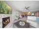 Spacious living room with fireplace, sectional sofa, and access to dining area at 9815 Harrell Ave # 302, Treasure Island, FL 33706