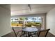 Small patio with table and chairs overlooking a waterfront view at 9815 Harrell Ave # 302, Treasure Island, FL 33706