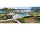 Community pool with lush landscaping and waterfront access at 9815 Harrell Ave # 302, Treasure Island, FL 33706