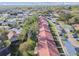 Aerial view of a neighborhood with red-roofed homes, trees, and parking at 11511 113Th St # 27C, Largo, FL 33778