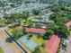 Aerial view of a community with a tennis court, pool, trees, and ample parking at 11511 113Th St # 27C, Largo, FL 33778