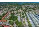 Aerial view of a residential complex surrounded by trees, featuring a pool and tennis court at 11511 113Th St # 27C, Largo, FL 33778