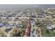Aerial view of a residential area with homes, pools, and trees near a main road at 11511 113Th St # 27C, Largo, FL 33778