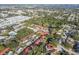 Aerial view of a neighborhood with houses, trees, and a glimpse of a lake or river at 11511 113Th St # 27C, Largo, FL 33778