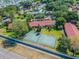 Aerial view of apartment buildings, a tennis court, and lush green landscaping at 11511 113Th St # 27C, Largo, FL 33778