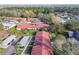 Aerial view of a residential community with red roofs, lush trees, and ample parking at 11511 113Th St # 27C, Largo, FL 33778