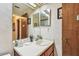 Compact bathroom with a single vanity, mirror, and door at 11511 113Th St # 27C, Largo, FL 33778