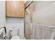 Simple bathroom with a shower, toilet, and wooden cabinet at 11511 113Th St # 27C, Largo, FL 33778