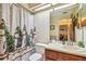 Bathroom with single vanity, toilet, and shower with decorative curtain at 11511 113Th St # 27C, Largo, FL 33778