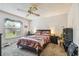 Bedroom with a bed, nightstands, and window view at 11511 113Th St # 27C, Largo, FL 33778