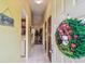 View of the foyer with a Christmas wreath on the door and a glimpse of the living room and kitchen at 11511 113Th St # 27C, Largo, FL 33778