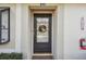 Close-up of the front door with decorative wreath and a visible smart lock at 11511 113Th St # 27C, Largo, FL 33778
