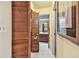 Hallway leading to a bathroom, featuring tiled floors and louvered closet doors at 11511 113Th St # 27C, Largo, FL 33778