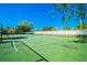 Community tennis court with green surface, net, and white fence at 11511 113Th St # 27C, Largo, FL 33778