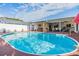 Large oval pool, patio, and adjacent hot tub at 12103 Kay Dr, Seminole, FL 33772