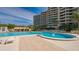 Resort-style pool with comfortable lounge chairs at 1211 Gulf Of Mexico Dr # 910, Longboat Key, FL 34228