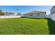 Expansive backyard featuring a large, well-maintained green lawn and fenced perimeter at 13388 Great Plains Dr, Riverview, FL 33579