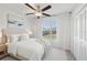 Serene bedroom featuring a comfortable bed, soft lighting, and a view of the outdoors at 13388 Great Plains Dr, Riverview, FL 33579