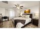 Comfortable bedroom with a ceiling fan, desk area, and warm, inviting decor at 13388 Great Plains Dr, Riverview, FL 33579