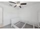 Simple bedroom with ceiling fan and white bed frame at 13388 Great Plains Dr, Riverview, FL 33579