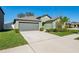 Charming single-story home with a well-maintained lawn and a two-car garage at 13388 Great Plains Dr, Riverview, FL 33579