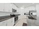 Well-equipped kitchen featuring stainless steel appliances and white cabinets with granite counters at 13388 Great Plains Dr, Riverview, FL 33579