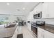 Modern kitchen features granite counters, stainless appliances, white cabinets and a breakfast nook area at 13388 Great Plains Dr, Riverview, FL 33579