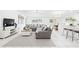 Bright, open-concept living area with a large sectional sofa, stylish decor, and abundant natural light at 13388 Great Plains Dr, Riverview, FL 33579