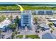 Aerial view showcasing a condo building's location near water and other buildings at 18320 Gulf Blvd # 303, Redington Shores, FL 33708