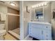Updated bathroom with gray tile shower and white vanity at 18320 Gulf Blvd # 303, Redington Shores, FL 33708