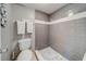 Gray tiled shower and toilet in this bathroom at 18320 Gulf Blvd # 303, Redington Shores, FL 33708
