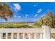 Private beach access with a white picket fence and lush vegetation at 18320 Gulf Blvd # 303, Redington Shores, FL 33708