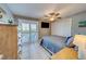 Bedroom with king bed, TV, and access to balcony at 18320 Gulf Blvd # 303, Redington Shores, FL 33708