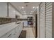Modern kitchen with stainless steel appliances and white cabinets at 18320 Gulf Blvd # 303, Redington Shores, FL 33708