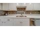 Modern kitchen with stainless steel appliances and white cabinets at 18320 Gulf Blvd # 303, Redington Shores, FL 33708