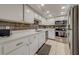 Modern kitchen with stainless steel appliances and white cabinets at 18320 Gulf Blvd # 303, Redington Shores, FL 33708
