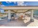 Covered patio area with tables and chairs for relaxing by the pool at 18320 Gulf Blvd # 303, Redington Shores, FL 33708