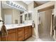 Double vanity bathroom with a large mirror and a glass shower at 225 Mystic Falls Dr, Apollo Beach, FL 33572