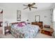 Comfortable bedroom with a ceiling fan, wooden furniture, and a patterned comforter at 2465 Northside Dr # 1808, Clearwater, FL 33761
