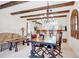 Dining area with unique chandelier, exposed ceiling beams, and view of living area at 2465 Northside Dr # 1808, Clearwater, FL 33761