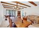 Dining area with large wooden table, chandelier, and a view into the living room at 2465 Northside Dr # 1808, Clearwater, FL 33761