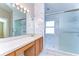 Bathroom features a single sink vanity, an enclosed glass shower, and modern fixtures at 2529 Clareside Dr, Valrico, FL 33596