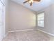 Neutral bedroom featuring a window, carpet flooring and a ceiling fan at 2529 Clareside Dr, Valrico, FL 33596