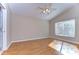 Neutral bedroom with wood floors, window for natural light, and fan at 2529 Clareside Dr, Valrico, FL 33596