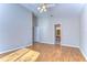 Bedroom with wood floors, open doorway to bath, neutral walls and a ceiling fan at 2529 Clareside Dr, Valrico, FL 33596